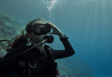 Masque de plongée à réalité augmentée : que vaut AREX ONE ? Plongeur en immersion portant un masque de plongée à réalité augmentée dans une eau bleue